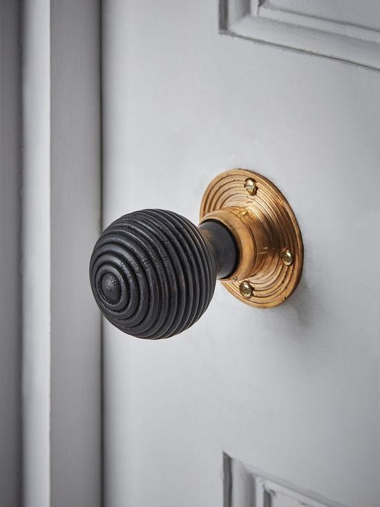 front image of cox-cox-beehive-door-knob-black-brass
