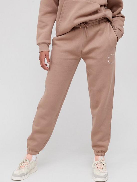 front image of pink-soda-pssnbspessentials-joggers-beige