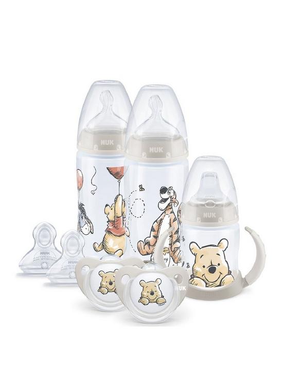 front image of nuk-winnie-the-pooh-feeding-bottles-teats-soother-and-cup-set-6-18m