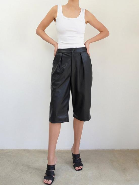 front image of religion-faux-leather-tailored-shorts-black