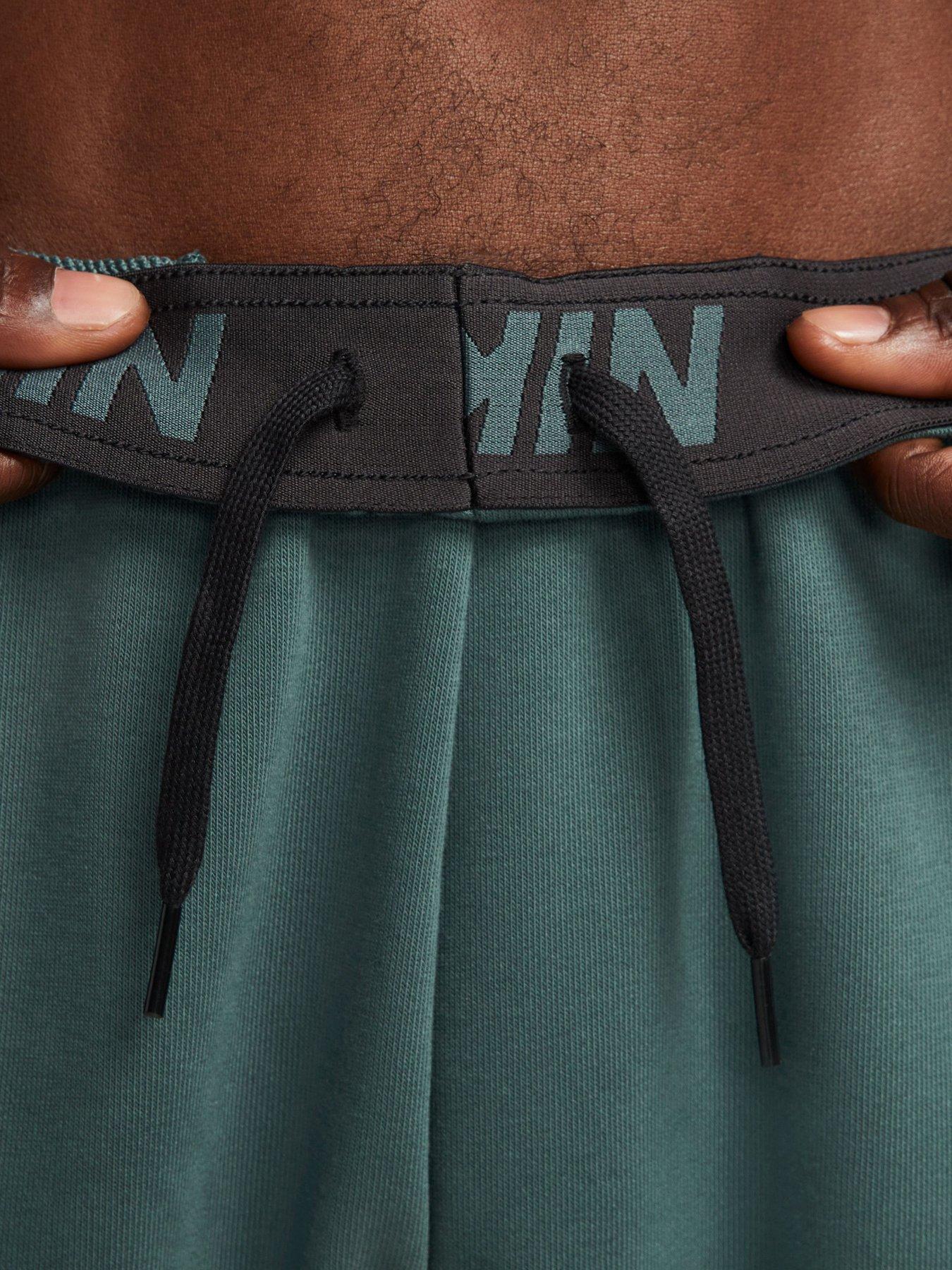 image of nike-train-dry-fit-taper-swoosh-pants-dark-green