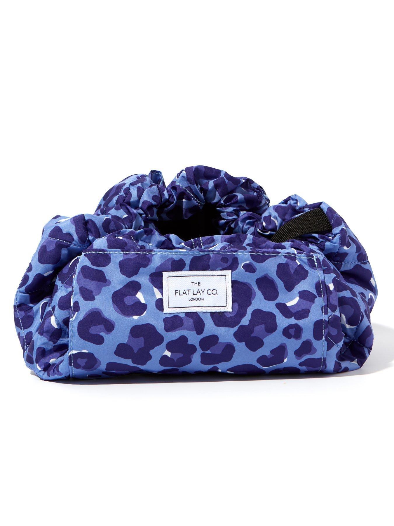  image of the-flat-lay-co-drawstring-makeup-bag-in-blue-leopard