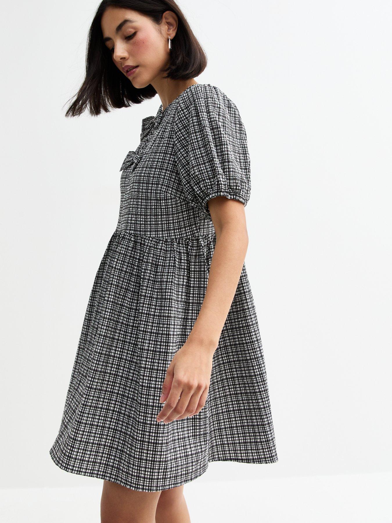 front image of new-look-gingham-bow-front-mini-dress-black