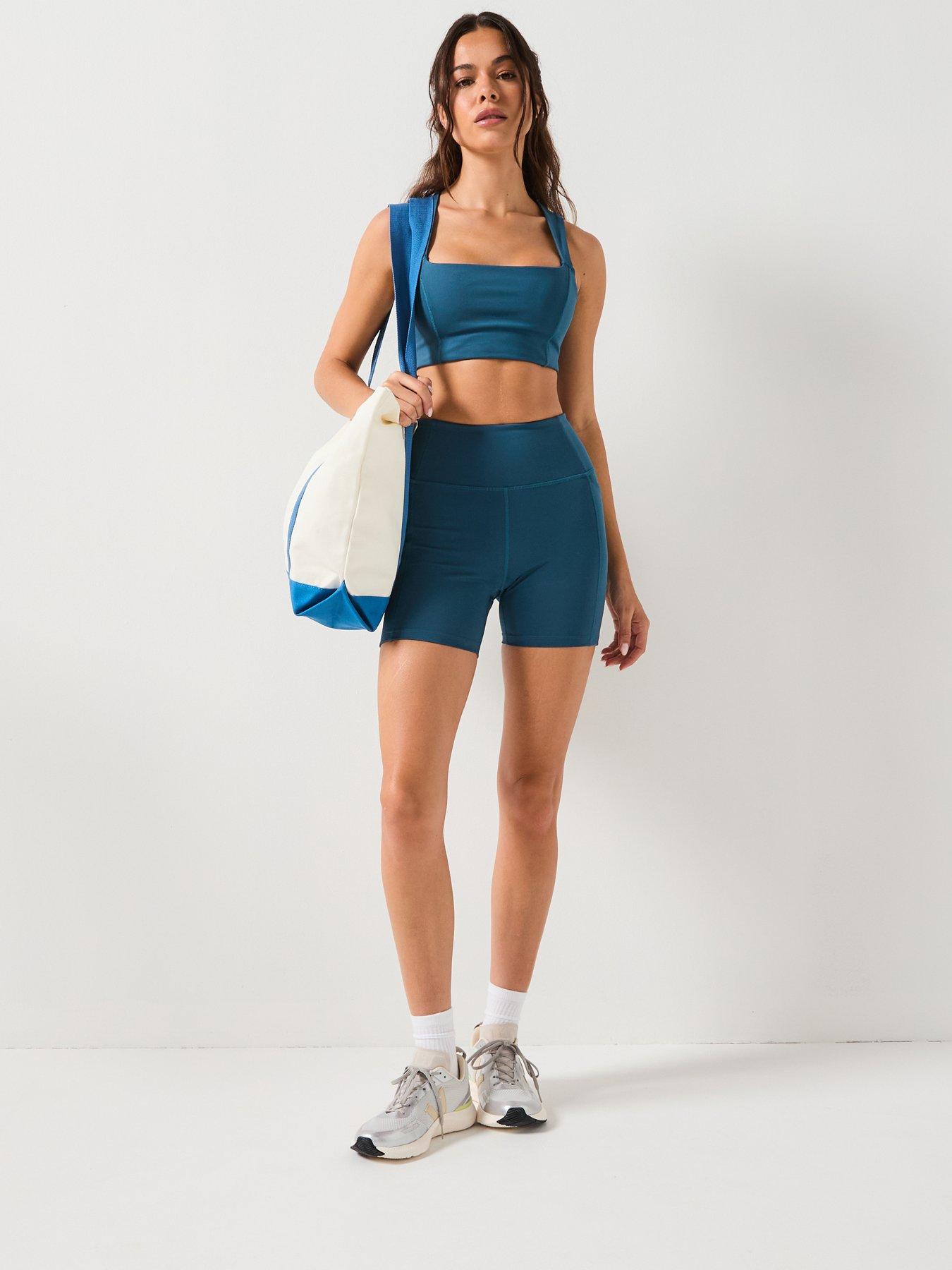  image of girlfriend-collective-womens-training-natalie-seamed-bra-open-back-blue