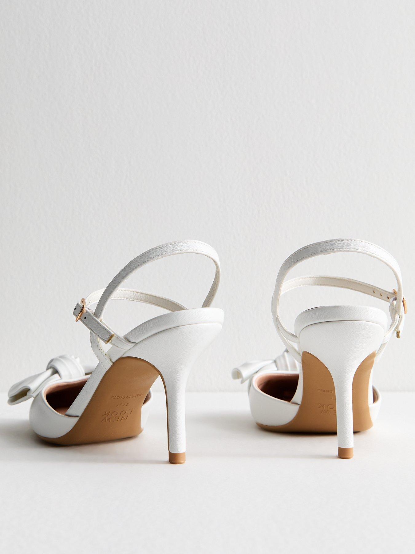  image of new-look-white-faux-leather-bow-applique-open-court-shoes