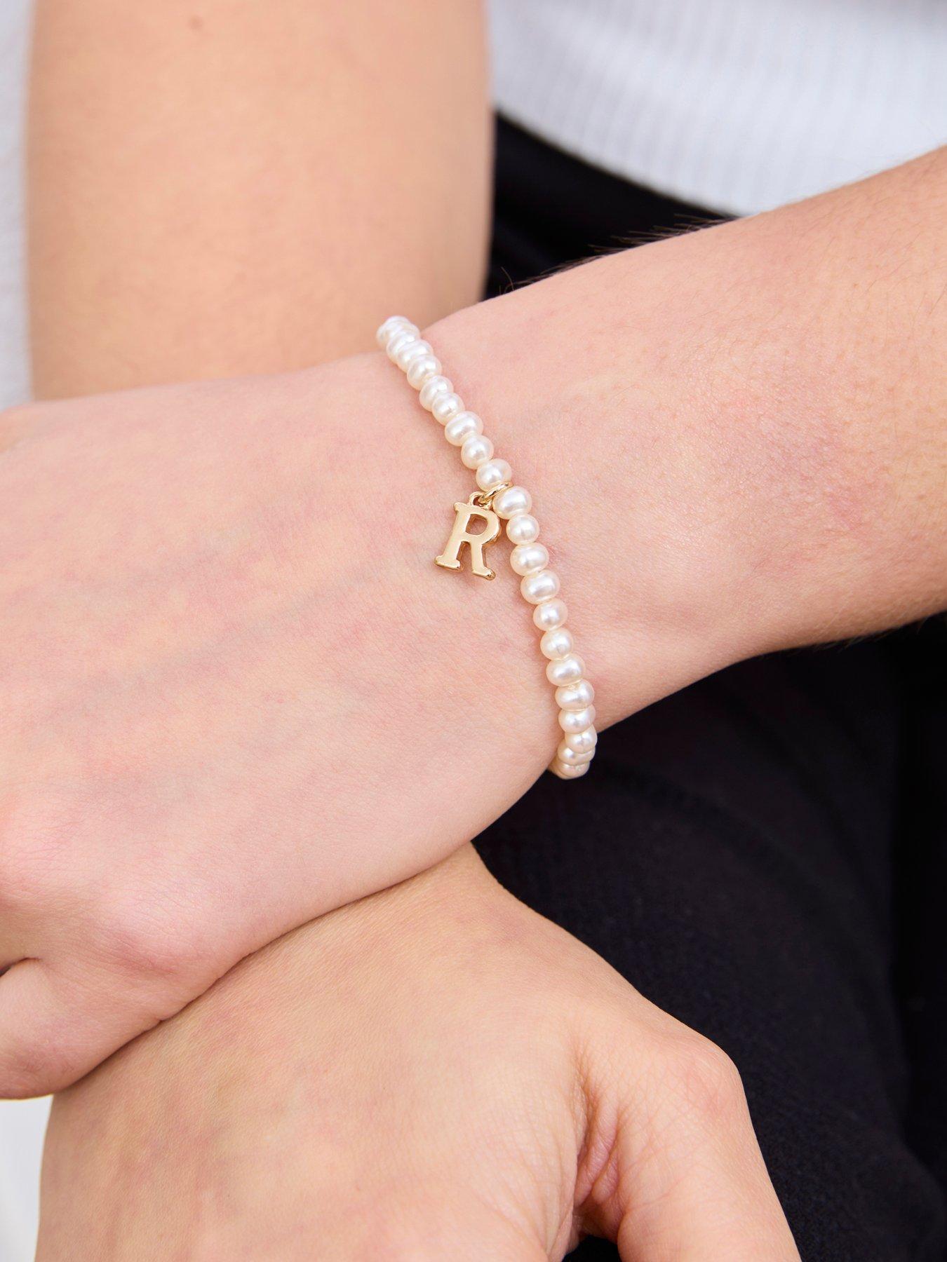 Image 2 of 4 of The Love Collection Pearl Stretch Bracelet with Gold Letter Charm