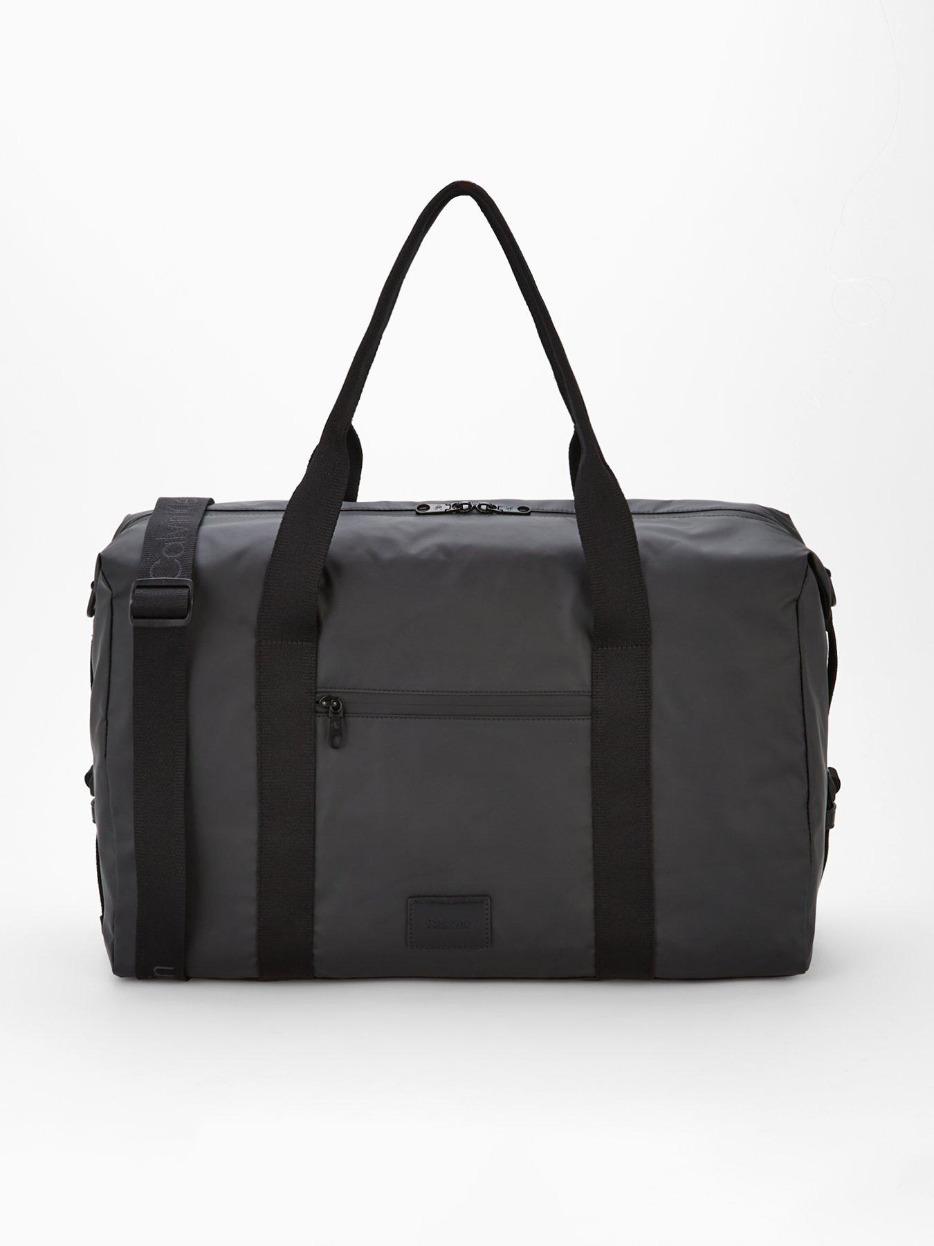 front image of calvin-klein-puff-utility-duffle-bag-black
