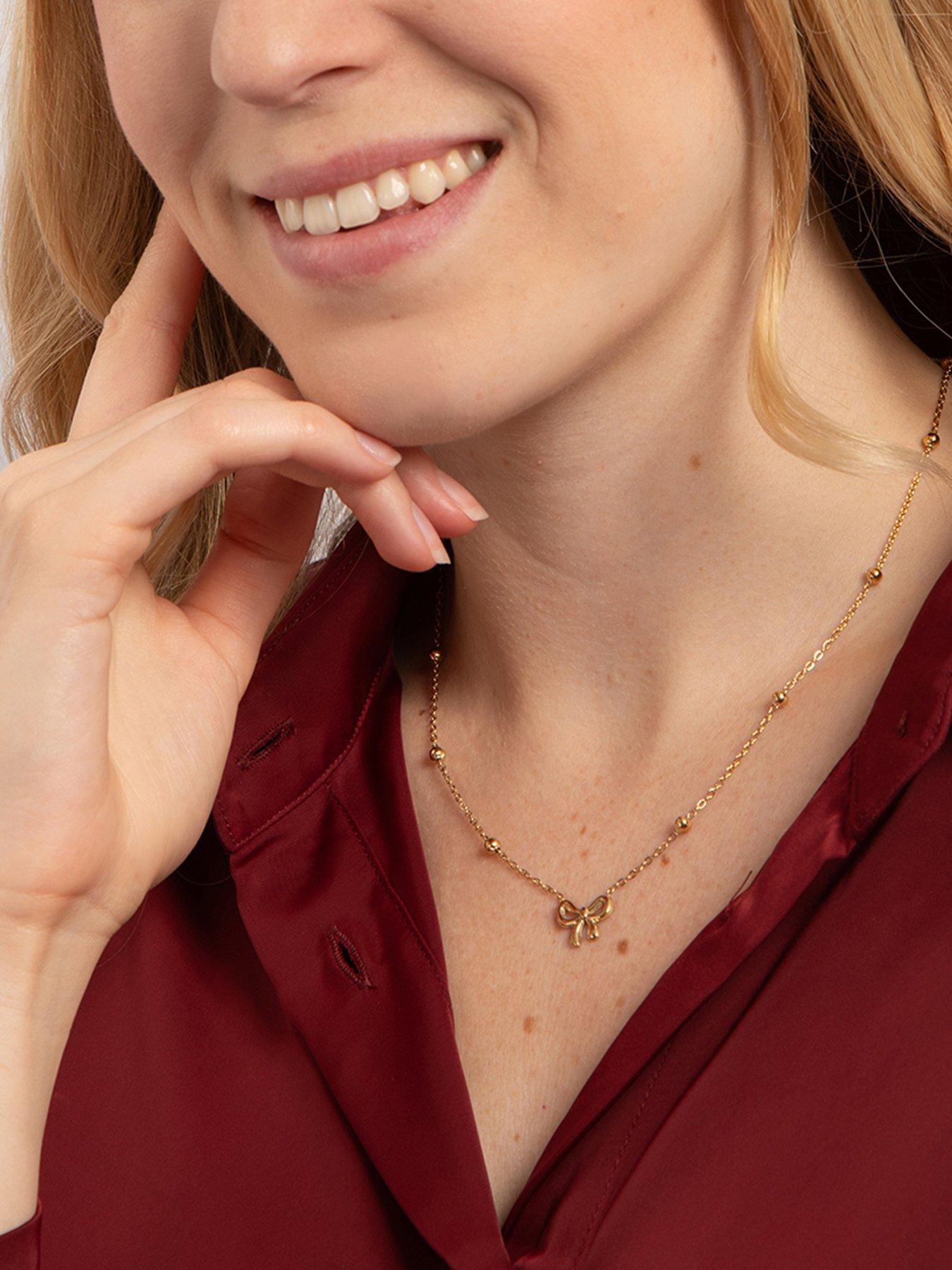 Image 2 of 4 of The Love Collection Gold Plated Stainless Steel Bow Saturno Necklace