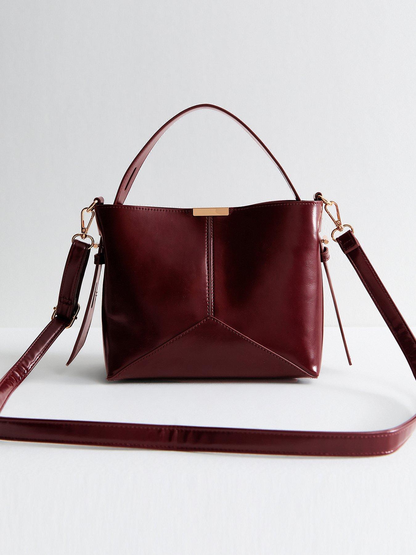 Image 1 of 5 of New Look Dark Burgundy High Shine Panelled Bucket Bag