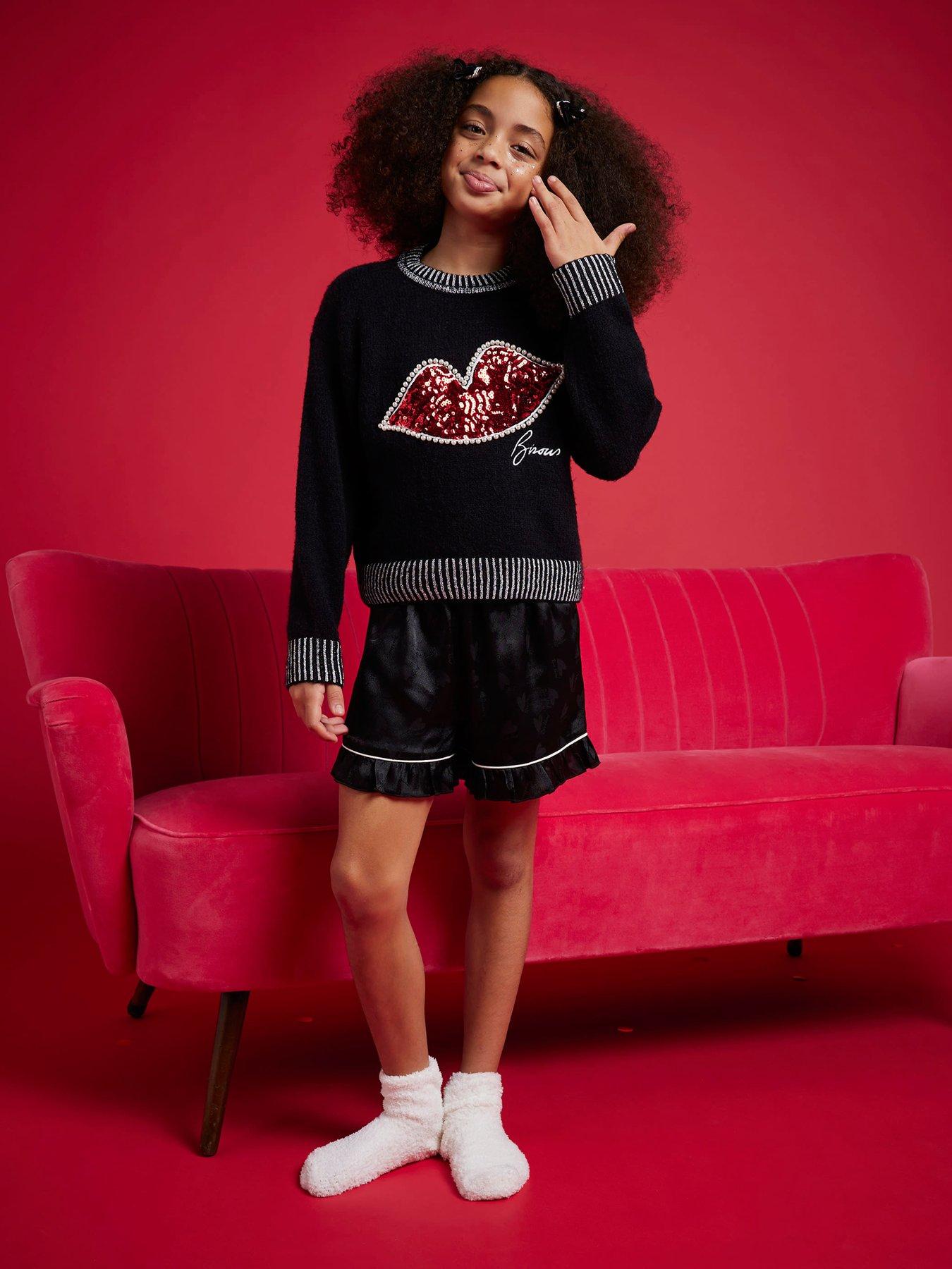 Image 1 of 6 of River Island Older Girls Nephthys Sequin Lips Christmas Jumper - Black