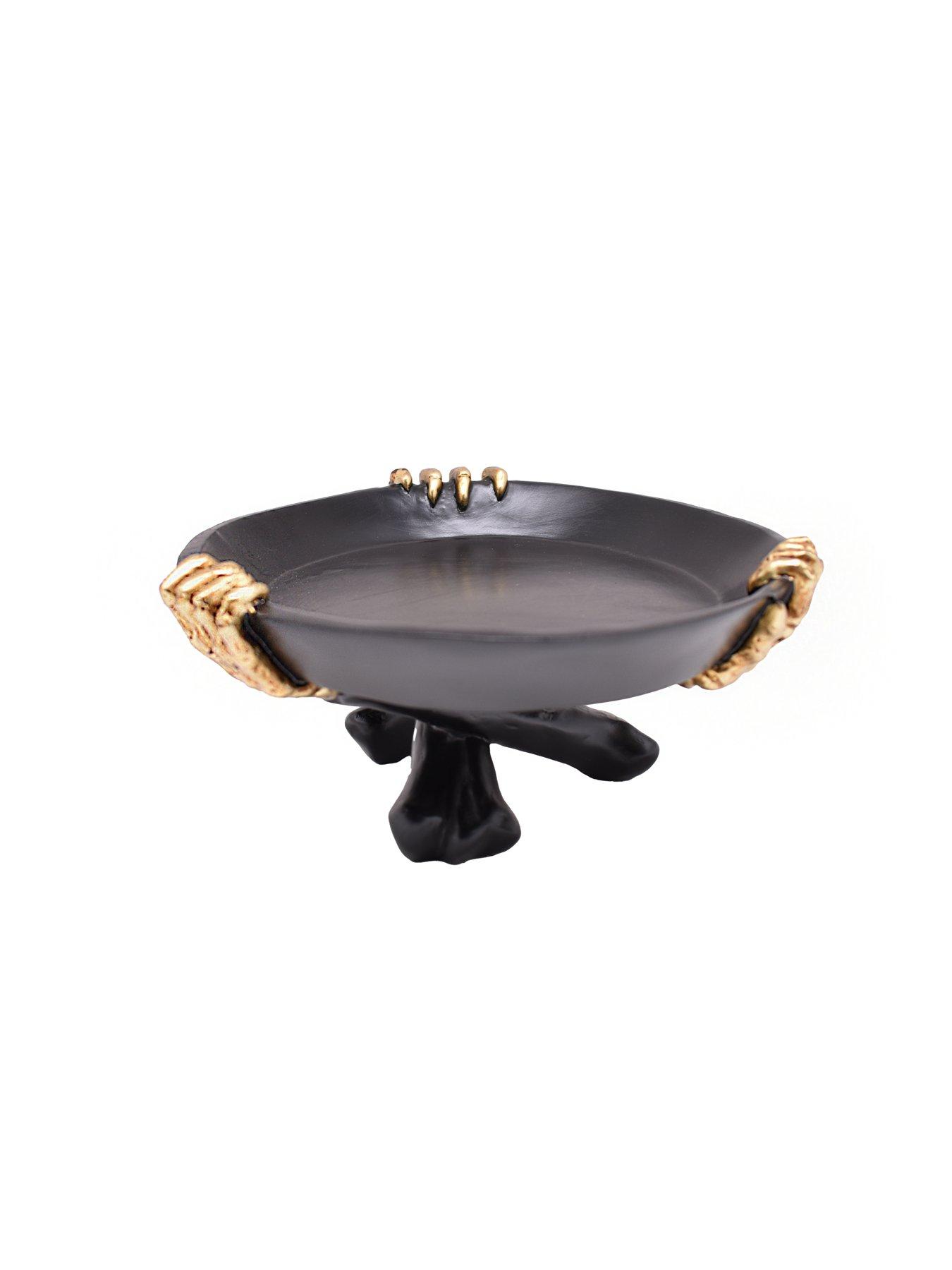 Image 1 of 1 of Festive 20cm Polyresin Black Plate On Stand Being Held By 3 Gold Skeleton Hands Table Top Decoration