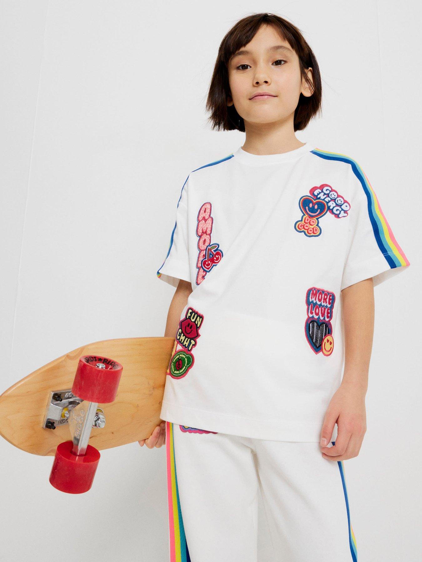 Image 1 of 6 of River Island Older Girls Badge Rainbow Stripe T-Shirt - White