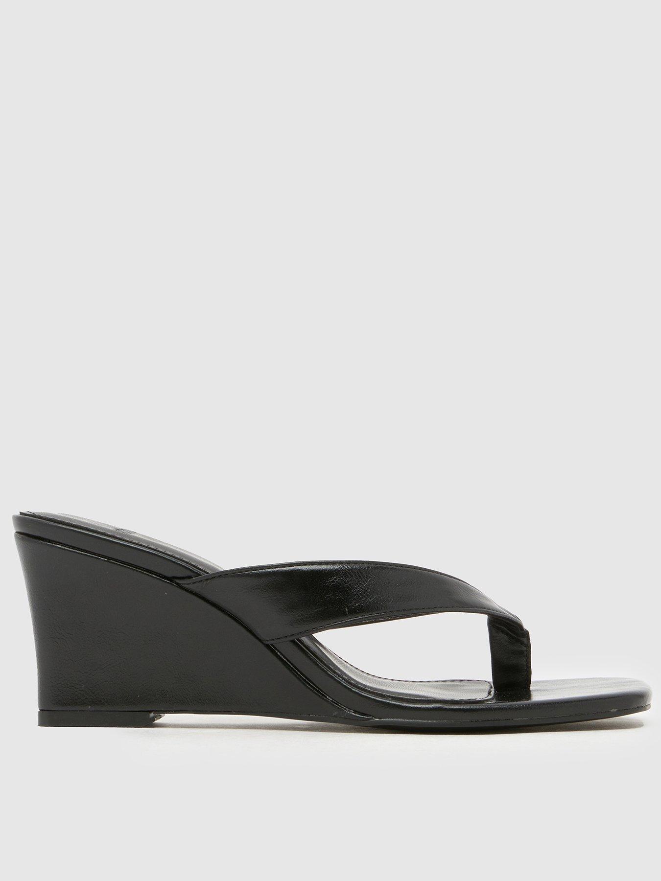 front image of schuh-solomon-wedge-sandal-black
