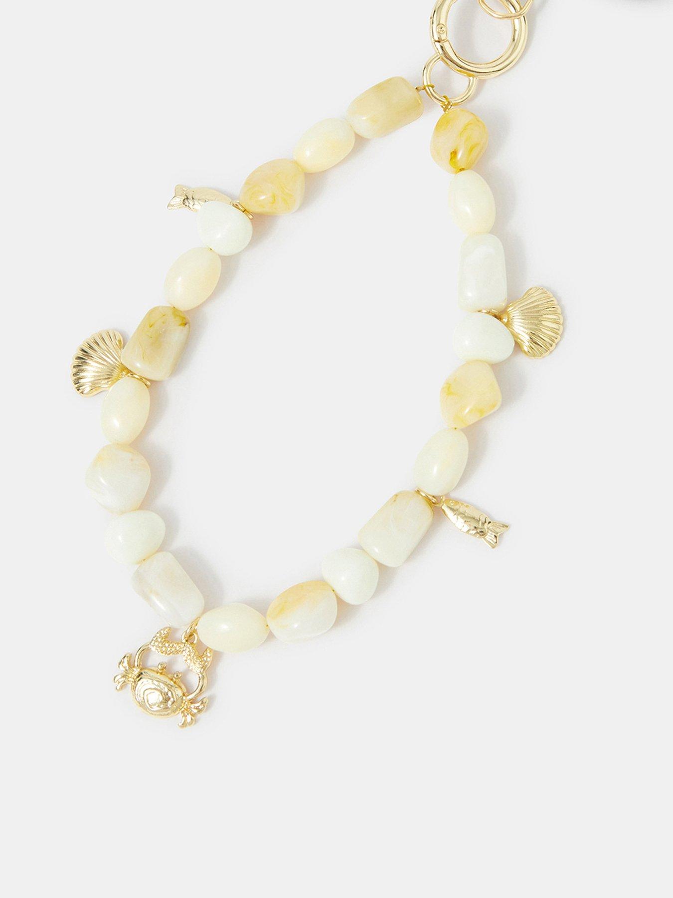 Image 1 of 2 of Accessorize Beaded Shell Charm Phone Wrist Strap
