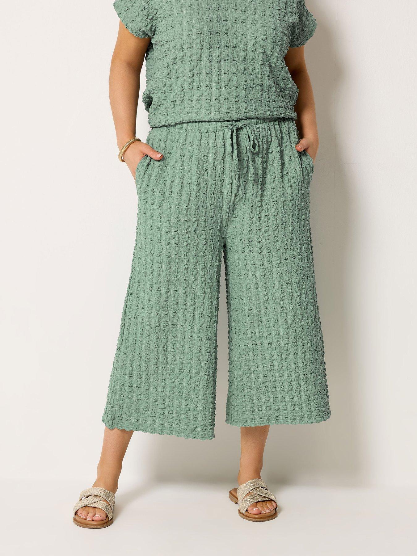 front image of yours-curve-bubble-textured-crops-co-ord-green