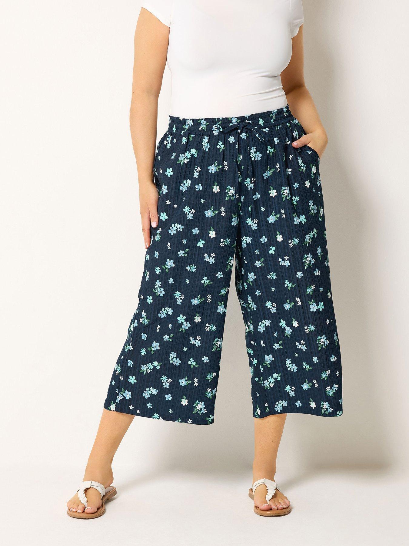 Image 1 of 4 of Yours Curve Crinkle Floral Print Crop Trousers - Blue