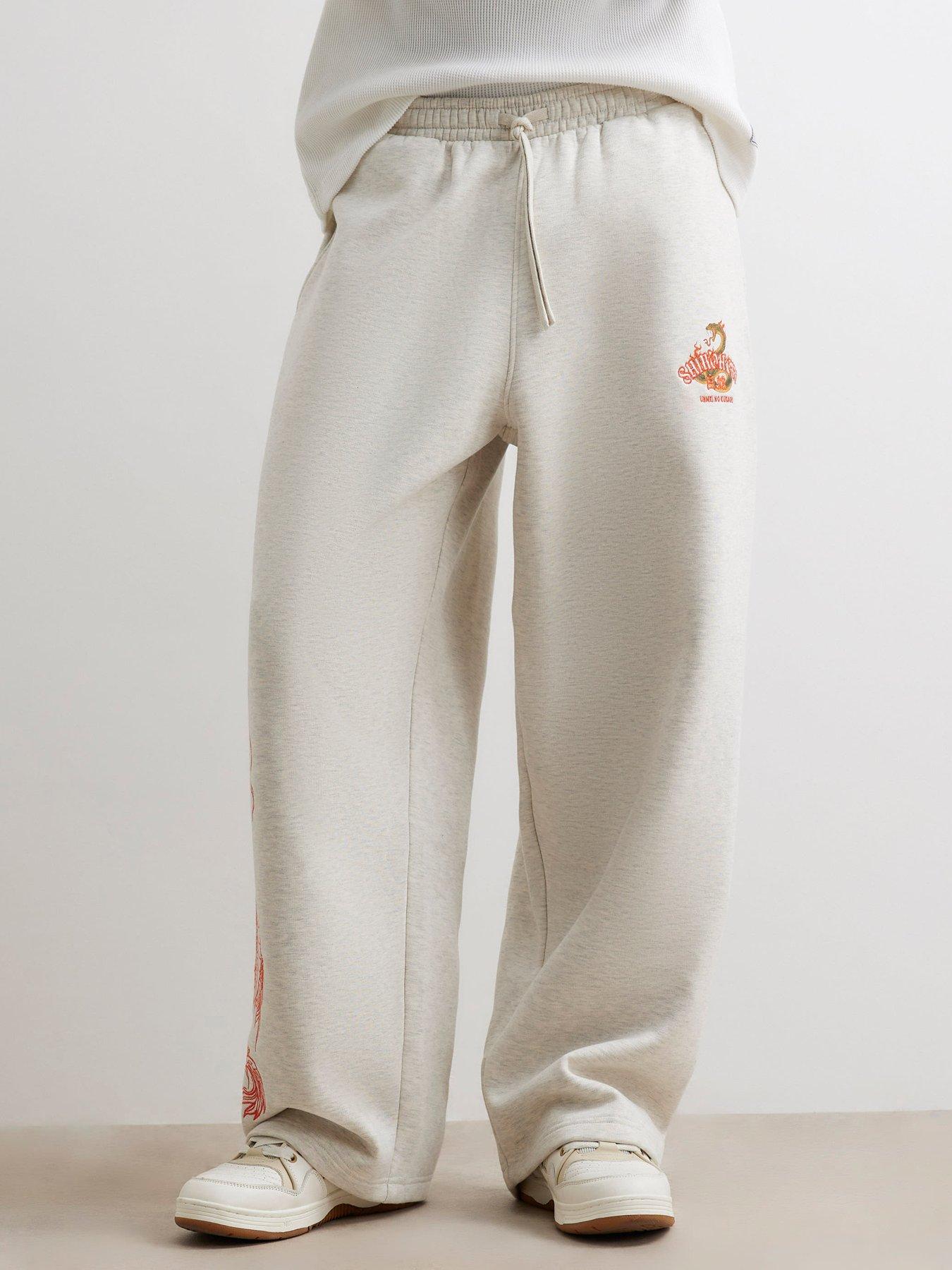 Image 1 of 6 of River Island Mens Wide Leg Snake Graphic Jogging Bottoms - Grey