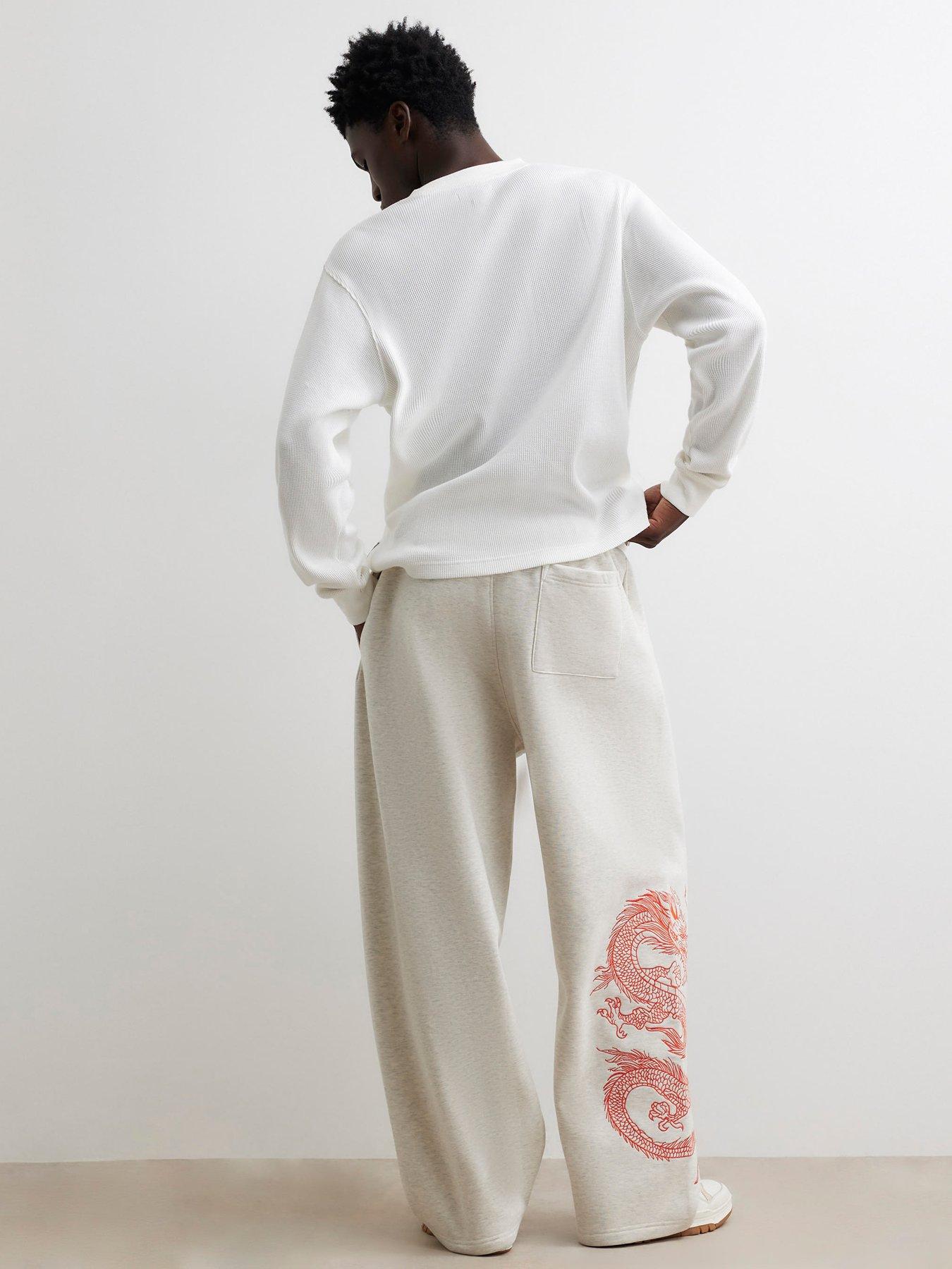 Image 2 of 6 of River Island Mens Wide Leg Snake Graphic Jogging Bottoms - Grey
