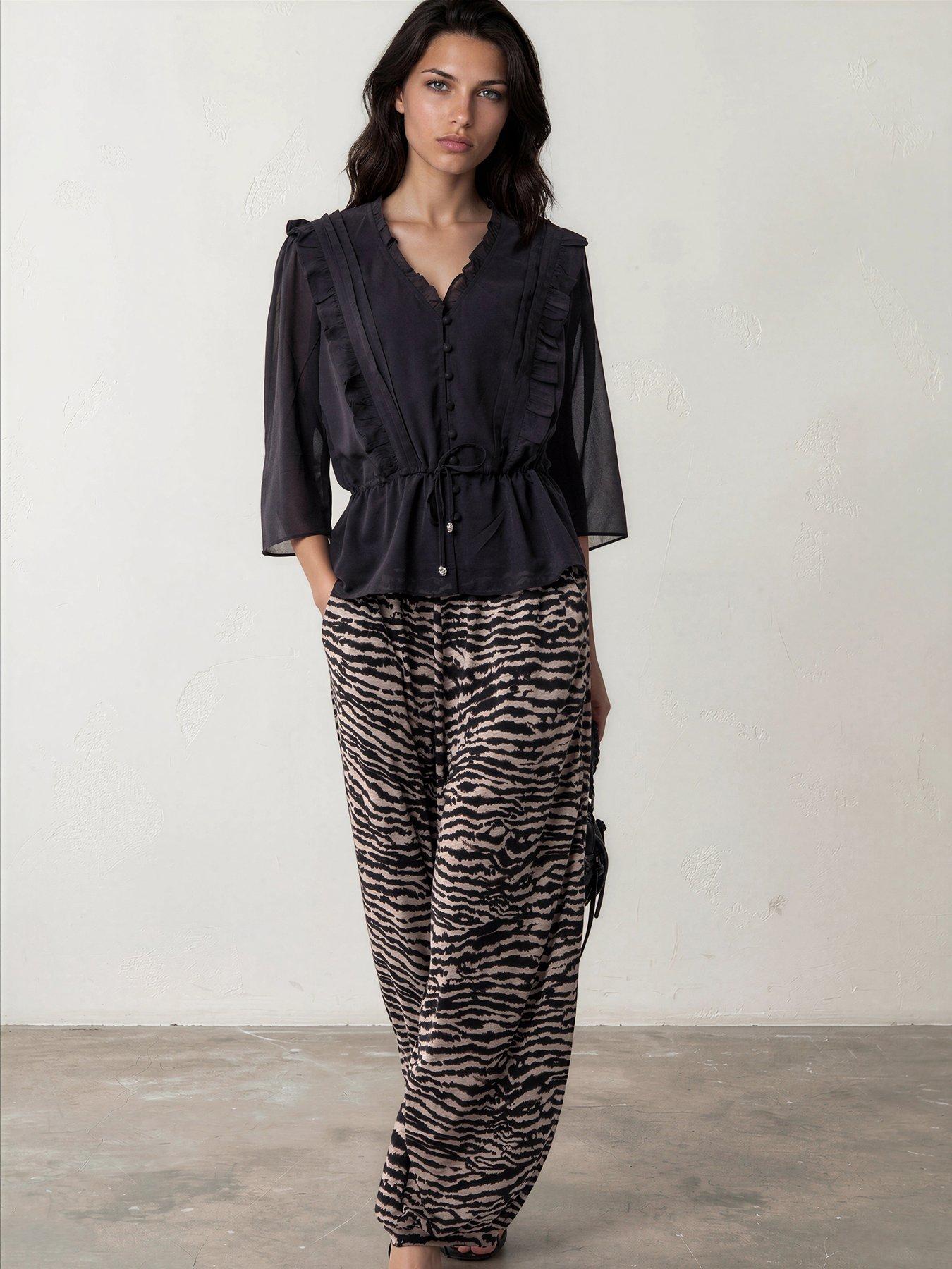 Image 1 of 7 of Religion Loose Fitting Lyla Jersey Trouser In Zebra Print With Cuffed Hem - Beige
